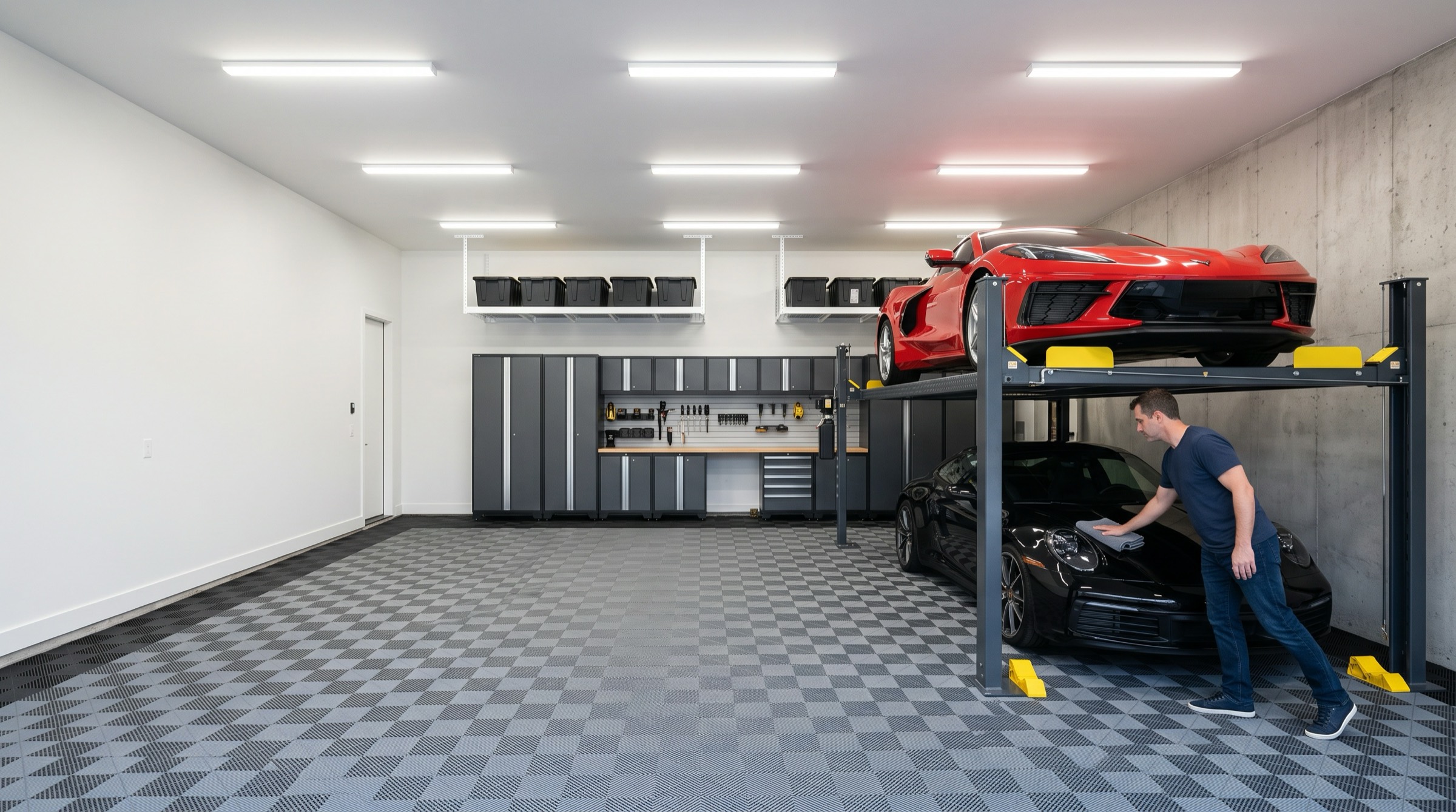 Organized garage with a four-post storage lift, modular floor tiles and wall cabinets